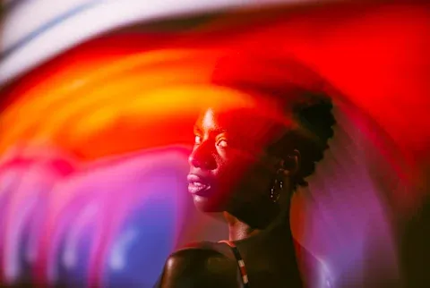 Woman Posing In The Studio With Colorful Lights