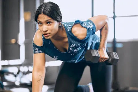 Fit Woman Working Out In A Gym