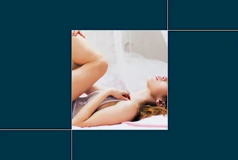 image of woman laying in bed on navy background