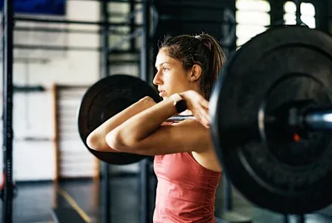 Woman holding heavy weights 