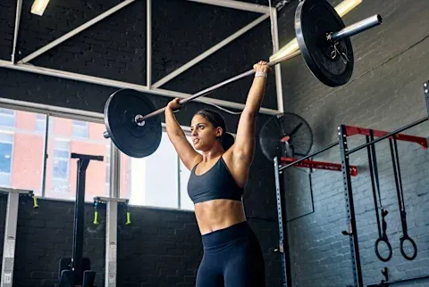 Woman lifting heavy weights 