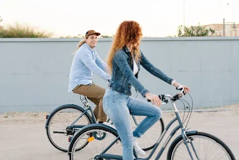 Young Couple On Bicycles In City