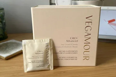 opened box of Vegamour GRO+ Advanced Supplement with single serving in front of box