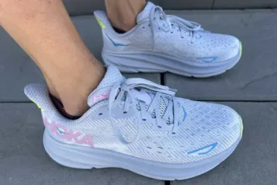 writer's feet with hoka clifton 9 shoes on