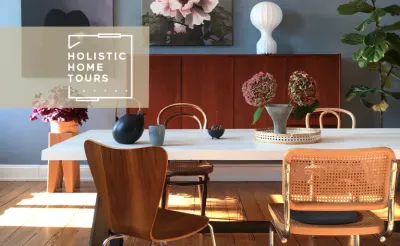 white dining table surrounded by wood and wicker chairs