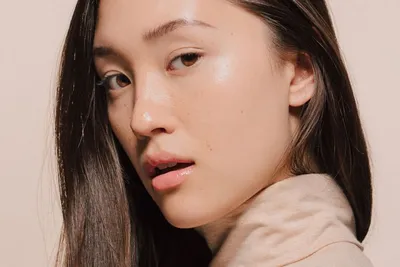 Portrait of a young woman with dewey skin