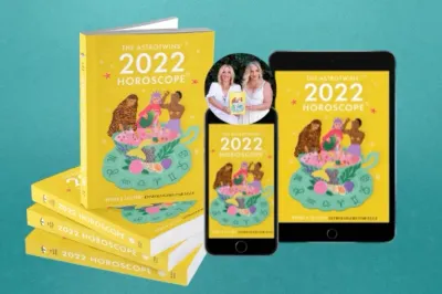 horoscope prediction book for 2022 with yellow cover on a phone and tablet
