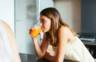 Teenager Drinking Juice In Morning
