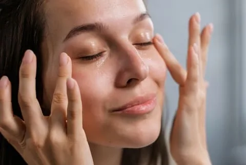 woman touching under eye cirlces woman touching under eye cirlces