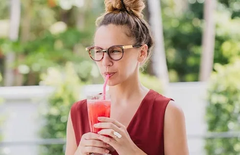 Woman Drinking A Smoothie At Home Woman Drinking A Smoothie At Home