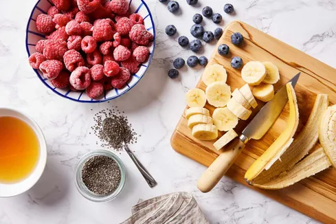Overhead Image of Raspberries, Blueberries, Bananas, Chia Seeds, and Honey Overhead Image of Raspberries, Blueberries, Bananas, Chia Seeds, and Honey