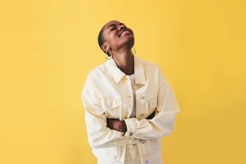 Happy Woman Wearing Yellow on a Yellow Background Happy Woman Wearing Yellow on a Yellow Background