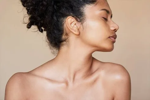 woman with glowing skin and tan background woman with glowing skin and tan background